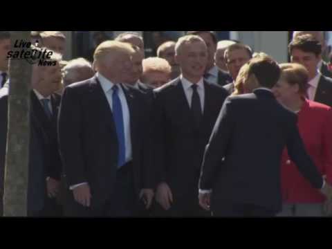 trump nearly pulls president macrons arm off after keeping him waiting