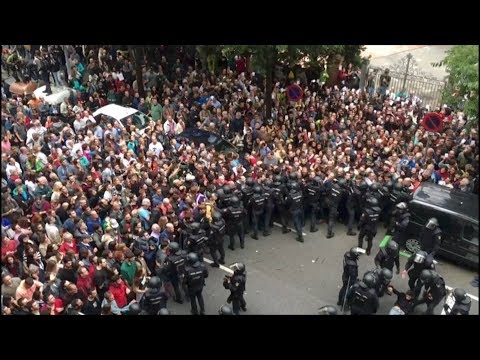tensions high as police hold back people outside barcelona